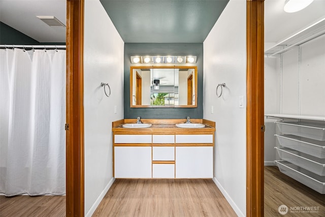9812 S 247th Ct, Kent, WA 98030 - bathroom featuring wood finished floors and double vanity
