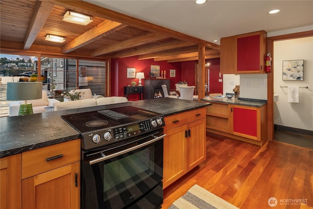 2339 Fairview Ave E Unit L, Seattle, WA 98102 - kitchen with electric range, wood finished floors, a wooden ceiling with exposed beams, dark countertops, and recessed lighting