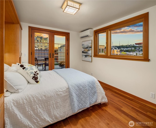 2339 Fairview Ave E Unit L, Seattle, WA 98102 - bedroom with a wall mounted AC, wood finished floors, french doors, and access to outside