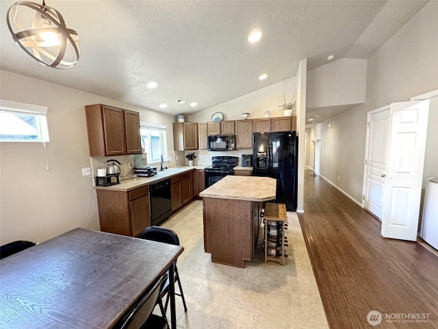 314 SW Homestead, College Place, WA 99324 - kitchen featuring black appliances, light countertops, lofted ceiling, healthy amount of natural light, and recessed lighting
