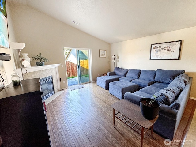 314 SW Homestead, College Place, WA 99324 - living room with vaulted ceiling, wood finished floors, and a tiled fireplace