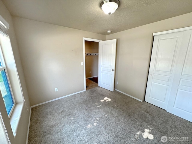 314 SW Homestead, College Place, WA 99324 - unfurnished bedroom featuring carpet floors, a closet, and a textured ceiling