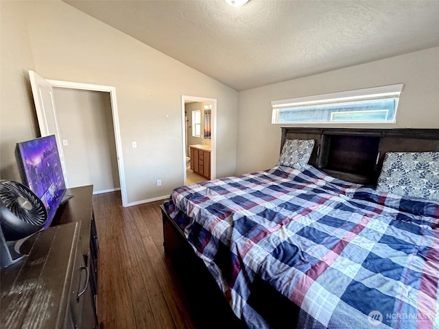 314 SW Homestead, College Place, WA 99324 - bedroom featuring wood finished floors, vaulted ceiling, a textured ceiling, and connected bathroom