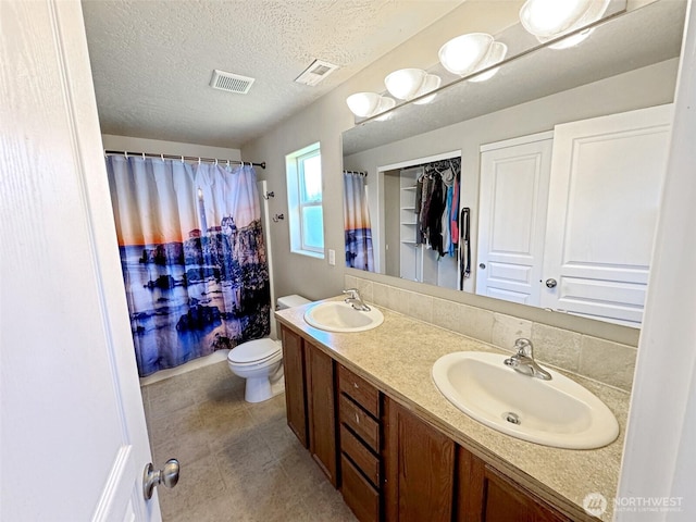 314 SW Homestead, College Place, WA 99324 - full bathroom featuring double vanity, tile patterned floors, a textured ceiling, and a shower with shower curtain