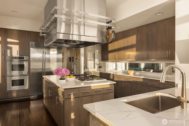 3611 Hunts Point Rd, Hunts Point, WA 98004 - kitchen featuring ventilation hood, appliances with stainless steel finishes, light stone counters, a center island, and recessed lighting