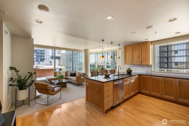 10610 NE 9th Pl Unit 1220, Bellevue, WA 98004 - kitchen featuring dishwasher, light wood-type flooring, brown cabinetry, a peninsula, and open floor plan