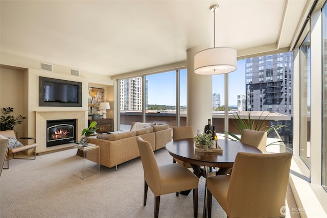 10610 NE 9th Pl Unit 1220, Bellevue, WA 98004 - dining space featuring a city view, a glass covered fireplace, and light colored carpet
