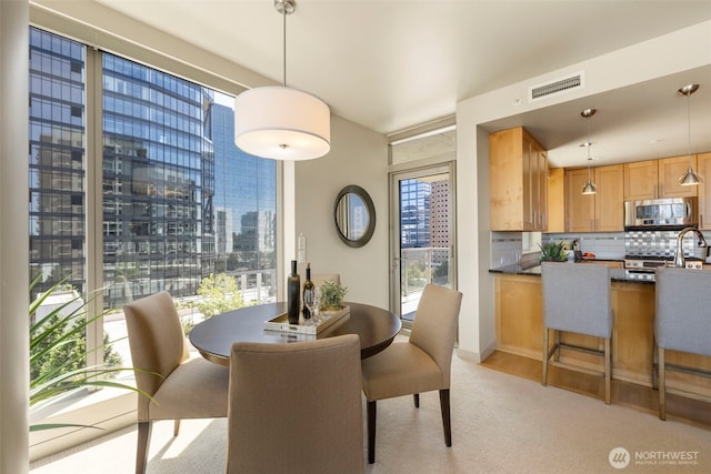 10610 NE 9th Pl Unit 1220, Bellevue, WA 98004 - dining room featuring a view of city and light carpet