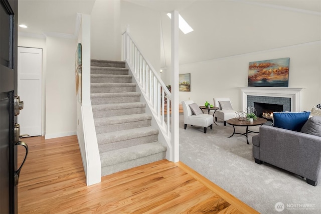 13063 SE 47th Pl, Bellevue, WA 98006 - staircase with a brick fireplace, wood finished floors, a skylight, and recessed lighting
