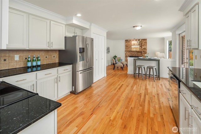 13063 SE 47th Pl, Bellevue, WA 98006 - kitchen with stainless steel refrigerator with ice dispenser, light wood-style flooring, tasteful backsplash, open floor plan, and a fireplace