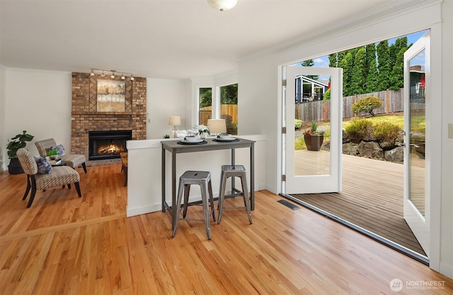 13063 SE 47th Pl, Bellevue, WA 98006 - living area featuring a fireplace, light wood finished floors, and rail lighting