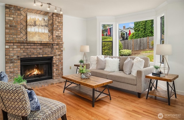 13063 SE 47th Pl, Bellevue, WA 98006 - living room featuring a brick fireplace, wood finished floors, and ornamental molding