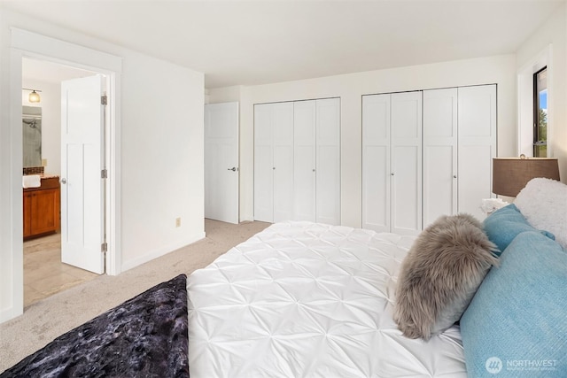 13063 SE 47th Pl, Bellevue, WA 98006 - bedroom featuring light colored carpet, multiple closets, and ensuite bath