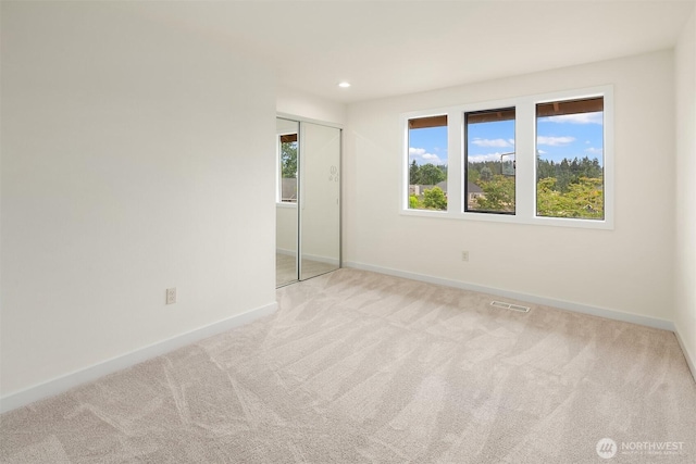 13063 SE 47th Pl, Bellevue, WA 98006 - carpeted empty room with healthy amount of natural light and recessed lighting