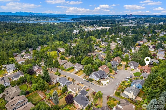 13063 SE 47th Pl, Bellevue, WA 98006 - aerial perspective of suburban area featuring a heavily wooded area and a large body of water