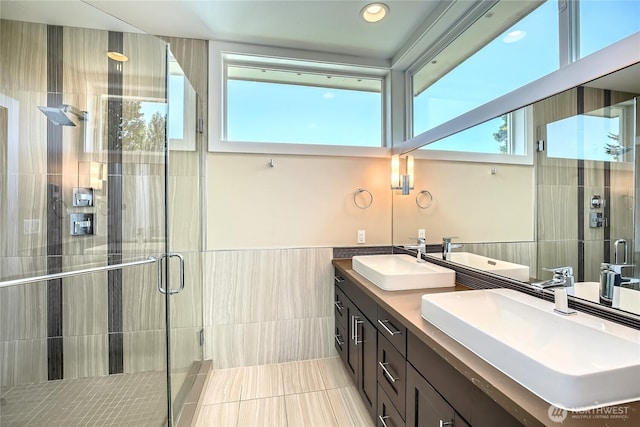 9544 3rd Ave NW, Seattle, WA 98117 - full bathroom with tile walls, double vanity, a stall shower, tile patterned floors, and wainscoting