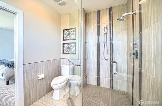 9544 3rd Ave NW, Seattle, WA 98117 - ensuite bathroom featuring tile walls, a stall shower, tile patterned flooring, and wainscoting