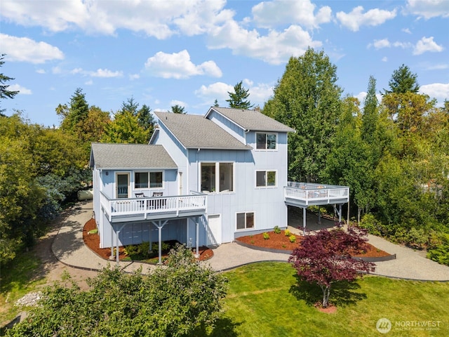 252 Myrtle St, Port Townsend, WA 98368 - back of property featuring a deck, a yard, board and batten siding, a shingled roof, and driveway