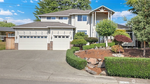 23728 135th Pl SE, Kent, WA 98042 - view of front of home with a garage, driveway, stone siding, and a shingled roof