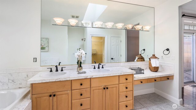 23728 135th Pl SE, Kent, WA 98042 - bathroom featuring a skylight, double vanity, a garden tub, and tile patterned flooring