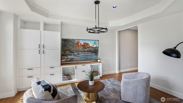 23728 135th Pl SE, Kent, WA 98042 - living area with a tray ceiling, a chandelier, light wood-style flooring, and crown molding