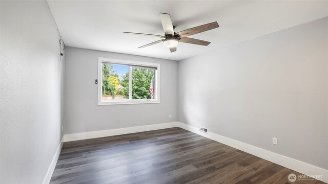 23728 135th Pl SE, Kent, WA 98042 - spare room featuring ceiling fan and dark wood-style flooring