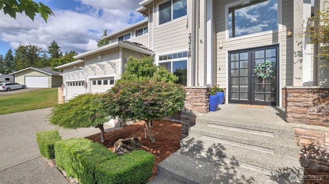 23728 135th Pl SE, Kent, WA 98042 - doorway to property featuring a garage and stone siding