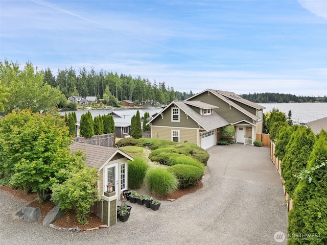 102 E Gibler Ln, Shelton, WA 98584 - view of front of house featuring a garage, driveway, an outbuilding, and a water view