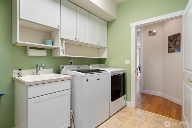 102 E Gibler Ln, Shelton, WA 98584 - laundry area featuring washing machine and clothes dryer, cabinet space, and light wood finished floors