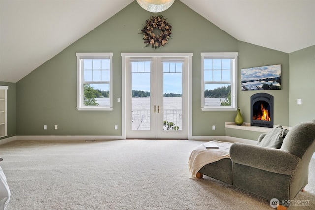 102 E Gibler Ln, Shelton, WA 98584 - sitting room featuring vaulted ceiling, a warm lit fireplace, carpet floors, and french doors