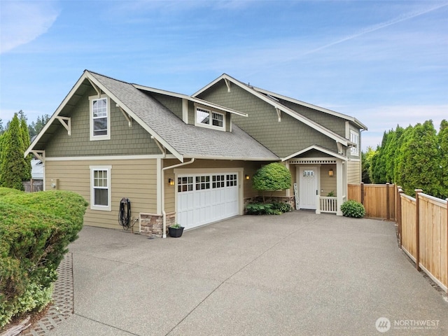 102 E Gibler Ln, Shelton, WA 98584 - craftsman inspired home featuring asphalt driveway, stone siding, a garage, and roof with shingles