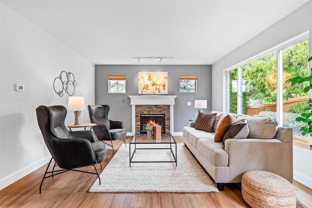 22418 SE 281st St, Maple Valley, WA 98038 - living room with a stone fireplace, wood finished floors, and track lighting