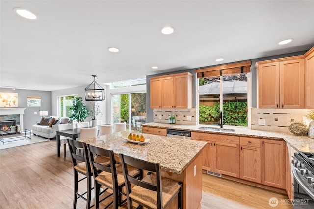 22418 SE 281st St, Maple Valley, WA 98038 - kitchen featuring appliances with stainless steel finishes, decorative backsplash, light wood-type flooring, open floor plan, and recessed lighting