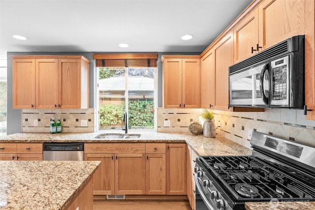 22418 SE 281st St, Maple Valley, WA 98038 - kitchen featuring stainless steel appliances, plenty of natural light, light brown cabinetry, light stone counters, and recessed lighting