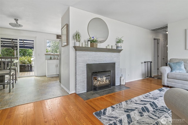 3041 S 201st St, Seatac, WA 98198 - living area with wood finished floors and a fireplace with flush hearth