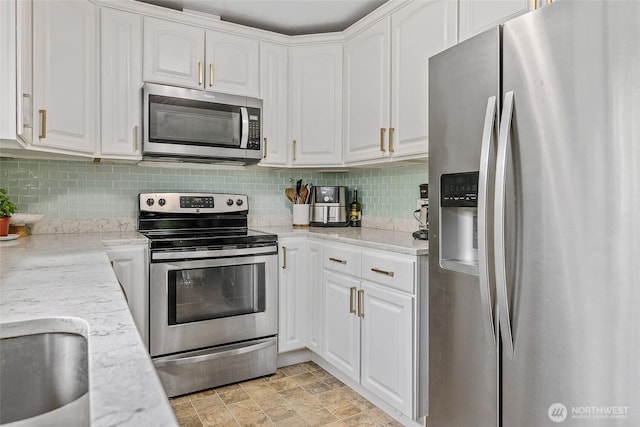 3041 S 201st St, Seatac, WA 98198 - kitchen with stainless steel appliances, white cabinetry, decorative backsplash, and light stone counters