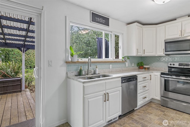 3041 S 201st St, Seatac, WA 98198 - kitchen with appliances with stainless steel finishes, decorative backsplash, and white cabinetry