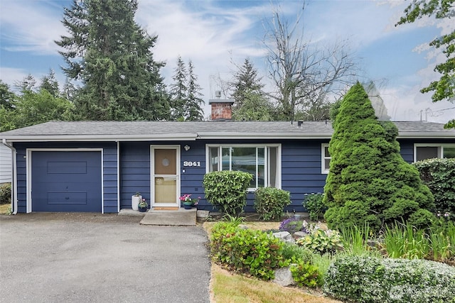3041 S 201st St, Seatac, WA 98198 - ranch-style house with an attached garage, a chimney, and asphalt driveway