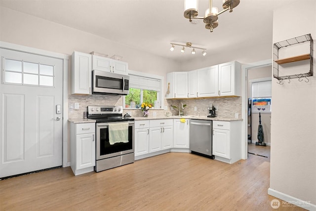 8153 Harborview Rd, Birch Bay, WA 98230 - kitchen featuring appliances with stainless steel finishes, decorative backsplash, and white cabinetry