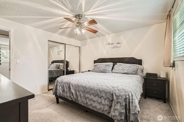 202 Elma Pl SE, Renton, WA 98059 - bedroom featuring light carpet, a closet, a textured ceiling, and a ceiling fan