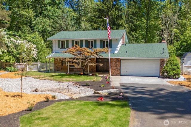 29701 52nd Ave E, Graham, WA 98338 - view of front facade with asphalt driveway, covered porch, a garage, brick siding, and roof with shingles