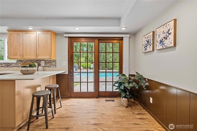 29701 52nd Ave E, Graham, WA 98338 - doorway to outside featuring recessed lighting, light wood-type flooring, and wainscoting