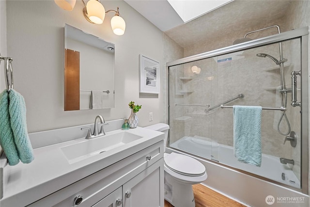 29701 52nd Ave E, Graham, WA 98338 - full bath with vanity, bath / shower combo with glass door, and wood finished floors