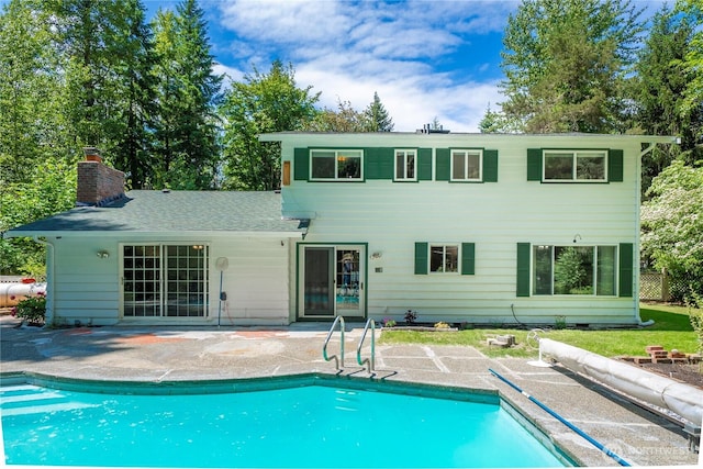 29701 52nd Ave E, Graham, WA 98338 - back of property with a patio, an outdoor pool, and a chimney