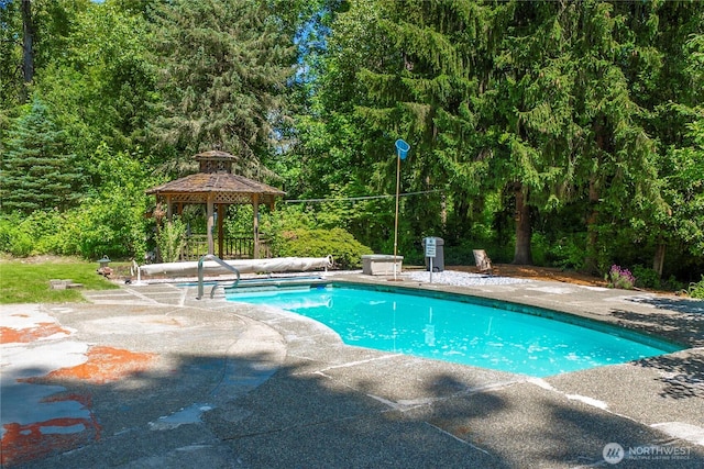29701 52nd Ave E, Graham, WA 98338 - view of swimming pool featuring a gazebo, a covered pool, a patio area, and a wooded view
