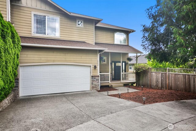 8233 NE 163rd Pl, Kenmore, WA 98028 - view of front of property featuring driveway, a garage, a shingled roof, a porch, and stone siding