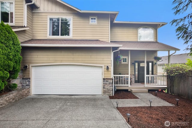 8233 NE 163rd Pl, Kenmore, WA 98028 - view of front of house with driveway, stone siding, covered porch, an attached garage, and a shingled roof