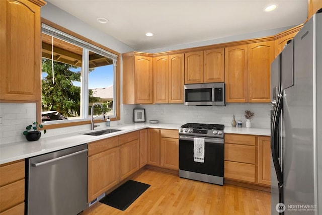 8233 NE 163rd Pl, Kenmore, WA 98028 - kitchen with stainless steel appliances, light wood finished floors, tasteful backsplash, light countertops, and recessed lighting