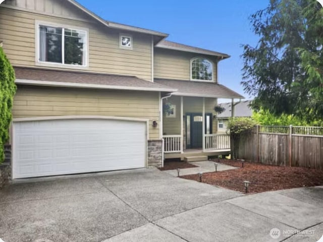 8233 NE 163rd Pl, Kenmore, WA 98028 - view of front facade featuring a garage, a porch, driveway, stone siding, and roof with shingles
