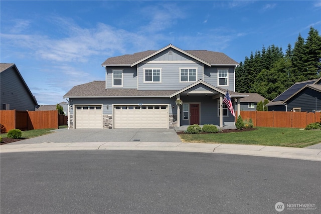 514 Wellington Pl, Sedro Woolley, WA 98284 - view of front of home featuring covered porch, driveway, a garage, board and batten siding, and stone siding